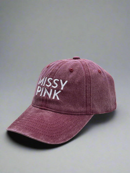 Maroon cap with 'MISSY PINK' text on a gray background