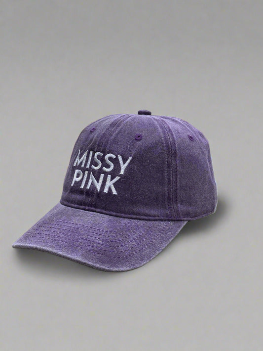 Purple cap with 'MISSY PINK' text on a gray background